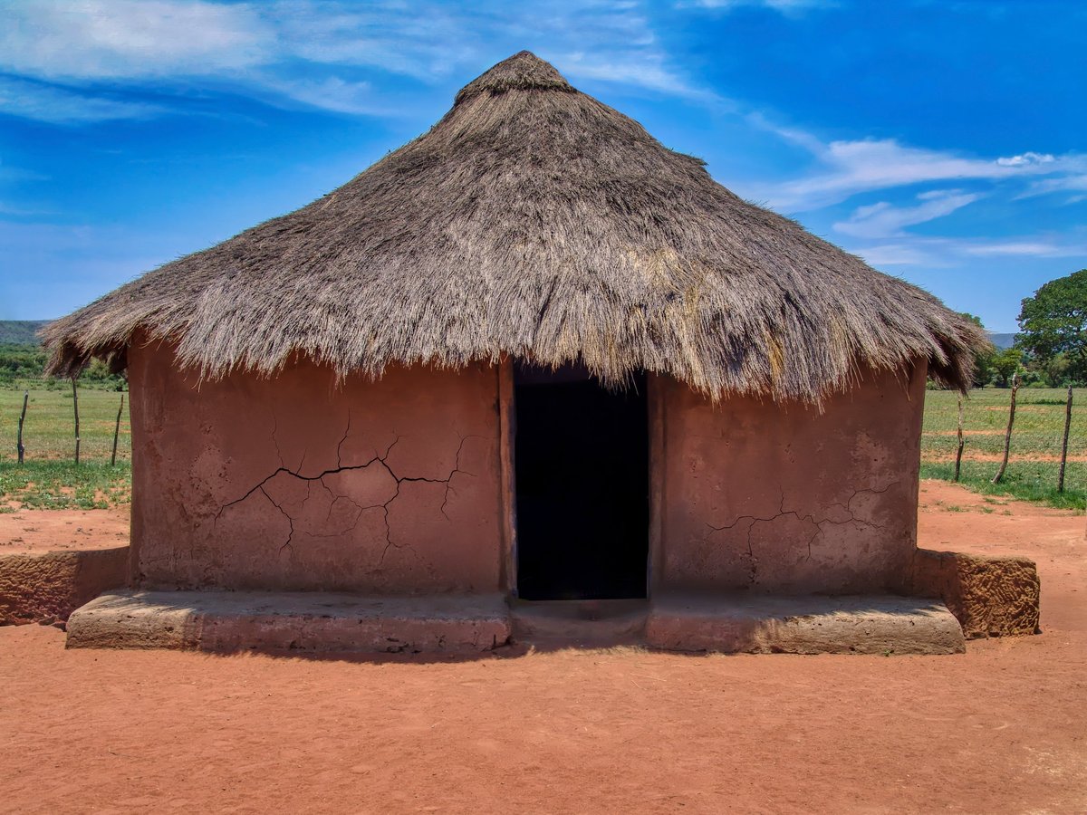 traditional african hut, rondavel with thatched roof and mud clay walls